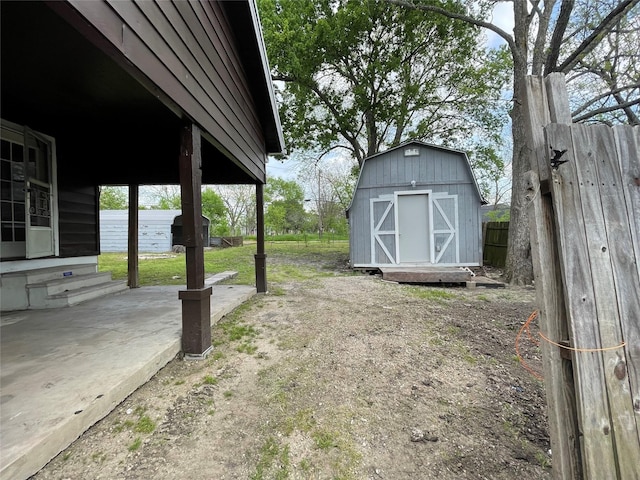 106 N 4th St, Celeste, TX 75423 - view of yard featuring entry steps, fence, an outbuilding, and a storage unit
