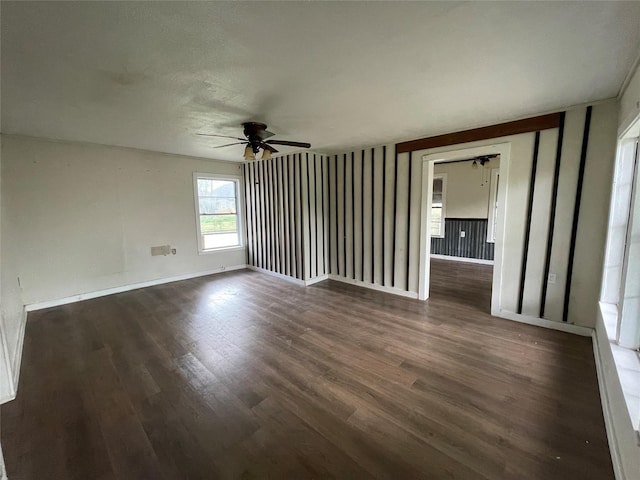 106 N 4th St, Celeste, TX 75423 - empty room with dark wood-style flooring, baseboards, and a ceiling fan