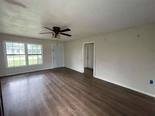 106 N 4th St, Celeste, TX 75423 - unfurnished living room featuring dark wood-style flooring, baseboards, and ceiling fan