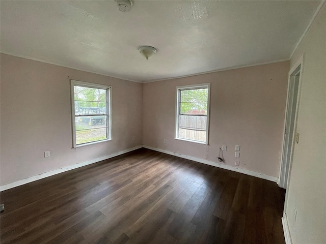 106 N 4th St, Celeste, TX 75423 - empty room featuring plenty of natural light, dark wood-type flooring, baseboards, and ornamental molding