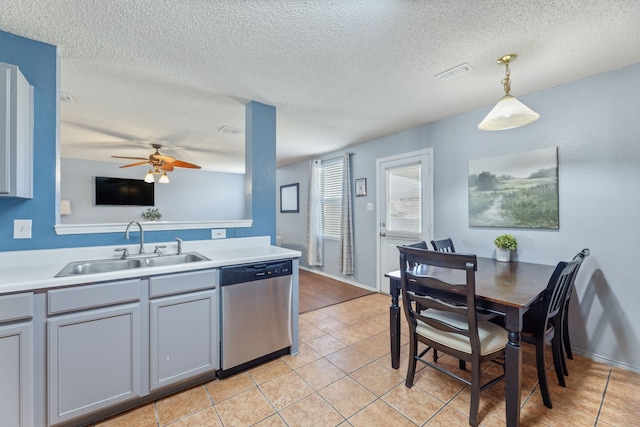 kitchen with dishwasher, a sink, ceiling fan, light tile patterned floors, and decorative light fixtures