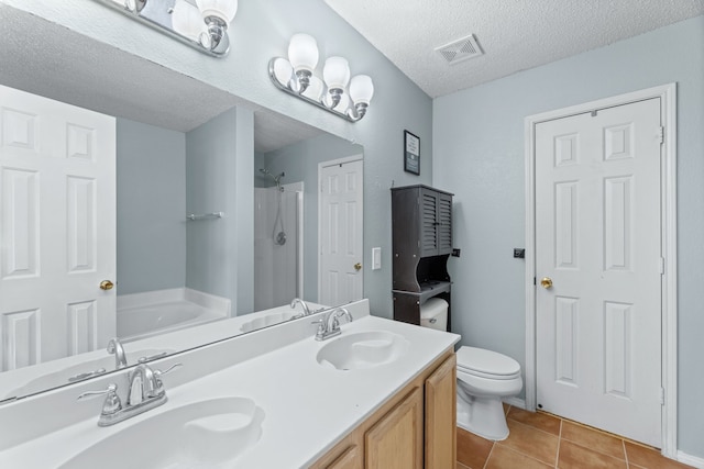 bathroom with a shower, a textured ceiling, tile patterned flooring, a garden tub, and toilet
