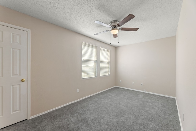 carpeted spare room featuring a ceiling fan, a textured ceiling, and baseboards