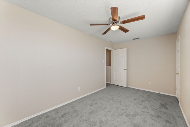 carpeted empty room with baseboards and ceiling fan