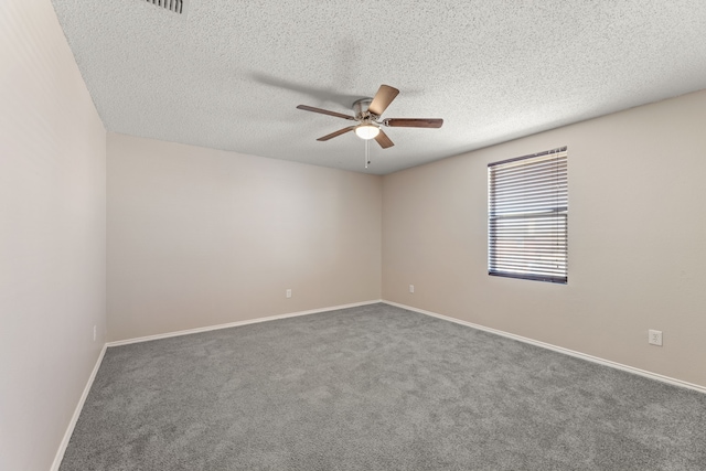 unfurnished room with ceiling fan, a textured ceiling, carpet, and baseboards