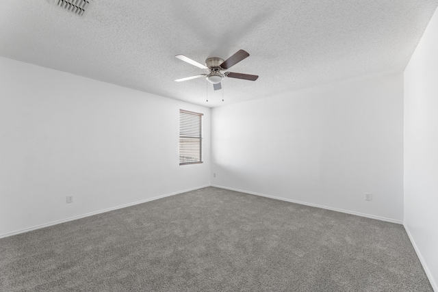 spare room featuring a ceiling fan, a textured ceiling, carpet, and baseboards
