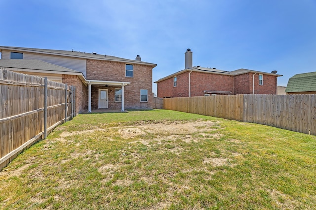rear view of house featuring brick siding and a ceiling fan