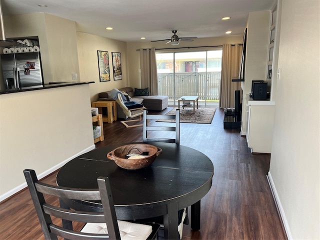 dining space featuring dark wood finished floors, baseboards, and ceiling fan