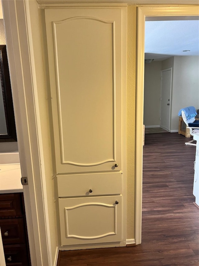 room details featuring baseboards and wood finished floors