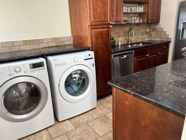 laundry area featuring wet bar, a sink, and separate washer and dryer