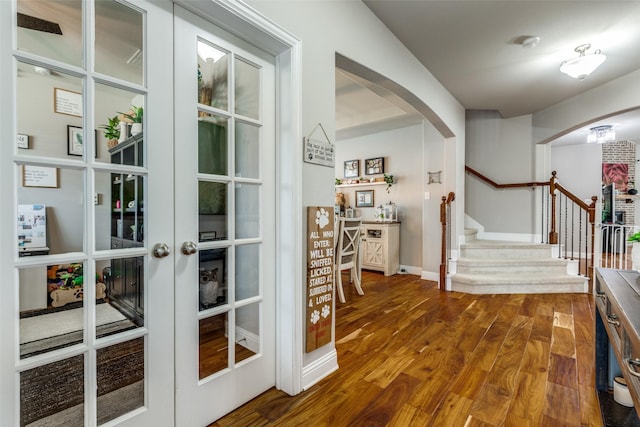 905 Bird Creek Dr, Little Elm, TX 75068 - hall with arched walkways, stairs, wood finished floors, french doors, and baseboards