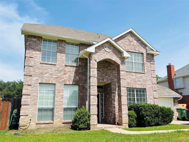 2212 Remmington Dr, Flower Mound, TX 75028 - view of front of house featuring fence, brick siding, and a garage