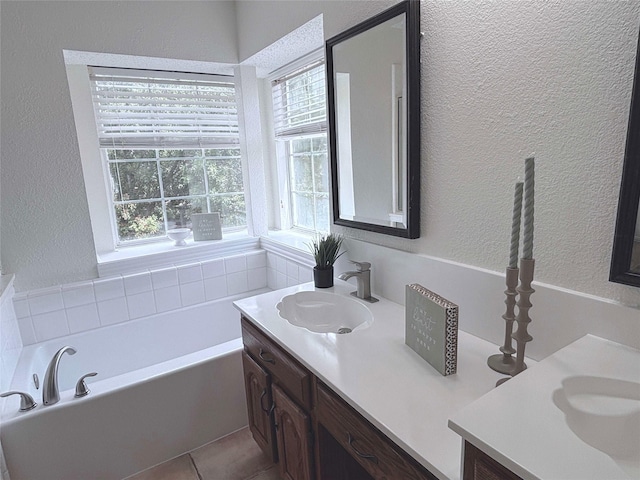 2212 Remmington Dr, Flower Mound, TX 75028 - bathroom with a textured wall, healthy amount of natural light, vanity, a bath, and tile patterned flooring