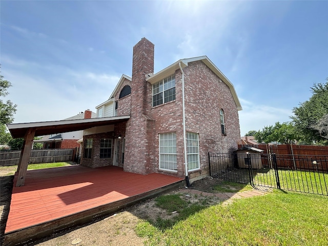 2212 Remmington Dr, Flower Mound, TX 75028 - back of property with a chimney, brick siding, and a wooden deck