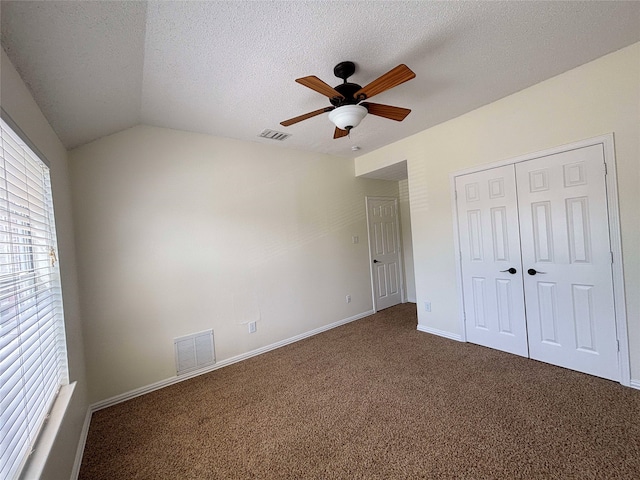 2212 Remmington Dr, Flower Mound, TX 75028 - unfurnished bedroom featuring dark colored carpet, baseboards, lofted ceiling, a textured ceiling, and a closet