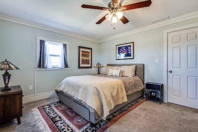 bedroom featuring crown molding, carpet floors, a ceiling fan, baseboards, and visible vents