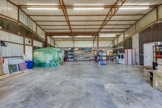 garage with independent washer and dryer and metal wall
