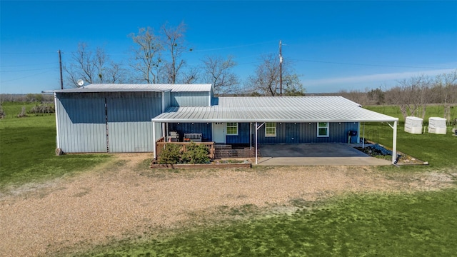 exterior space featuring metal roof and a front yard