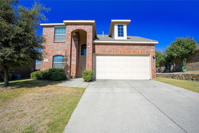 traditional-style house with brick siding, concrete driveway, a garage, and a front lawn