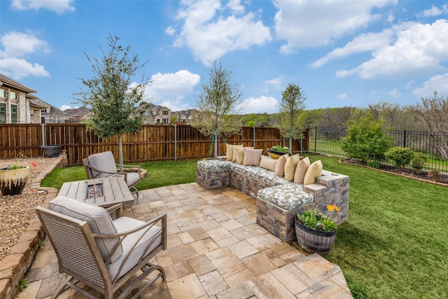 view of patio / terrace with a fenced backyard and an outdoor living space with a fire pit