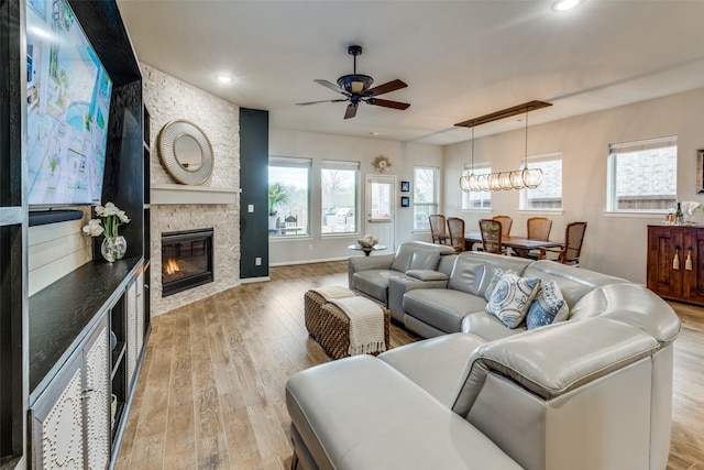 kitchen featuring decorative backsplash, appliances with stainless steel finishes, a center island, light wood-type flooring, and open floor plan