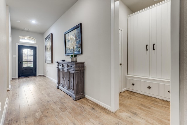 entryway featuring baseboards and wood finished floors