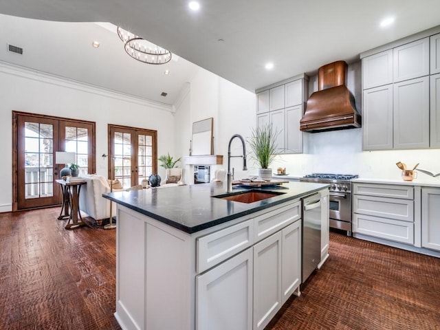 kitchen featuring custom range hood, a sink, visible vents, stainless steel appliances, and vaulted ceiling