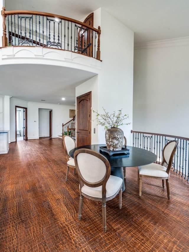 interior space featuring stairway, crown molding, and a towering ceiling