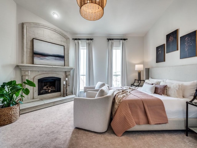 carpeted bedroom with a high end fireplace