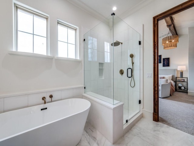 full bathroom with marble finish floor, a freestanding tub, a stall shower, a notable chandelier, and crown molding