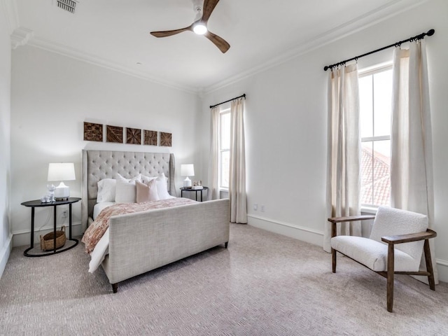 bedroom with baseboards, visible vents, carpet floors, and crown molding