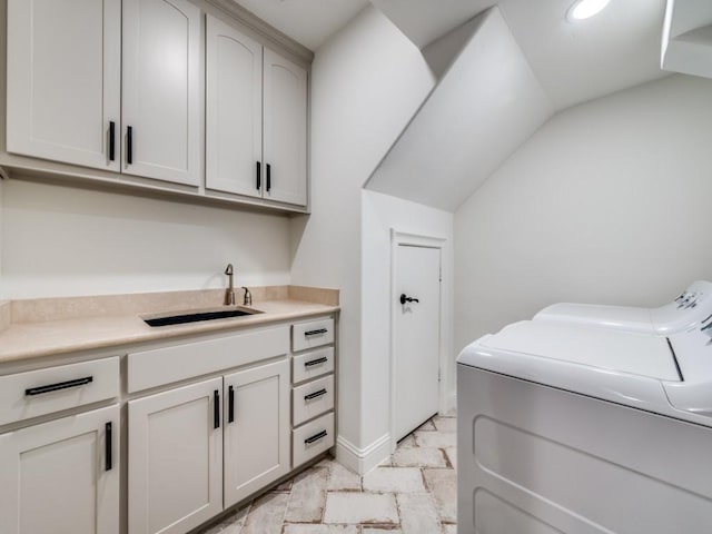 laundry room featuring washing machine and dryer, recessed lighting, cabinet space, and a sink