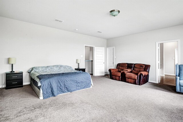 bedroom featuring baseboards, visible vents, and carpet