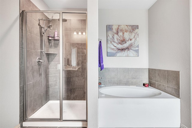 full bath with a stall shower and a bath