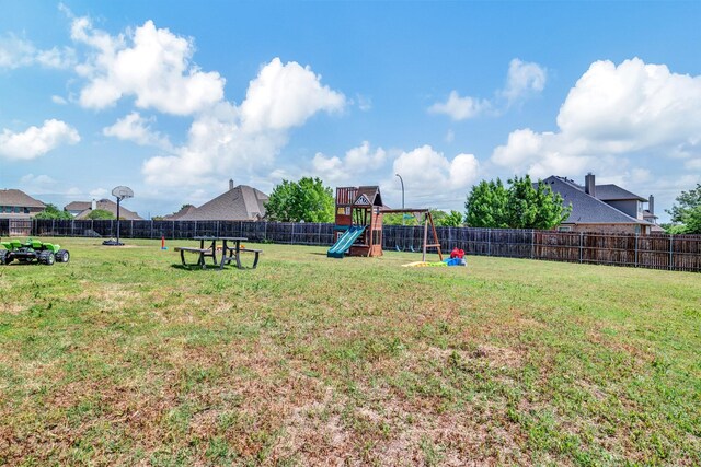 view of yard featuring a playground and a fenced backyard