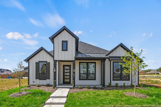 modern farmhouse with a standing seam roof, fence, metal roof, board and batten siding, and a shingled roof