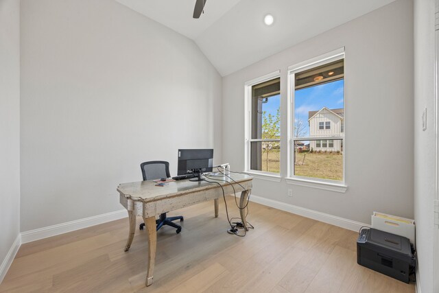 office space with baseboards, lofted ceiling, wood finished floors, and ceiling fan