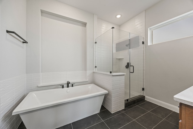 full bath with a shower stall, tile patterned floors, a freestanding tub, and vanity