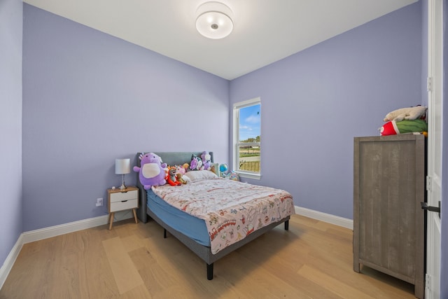 bedroom featuring baseboards and light wood-type flooring