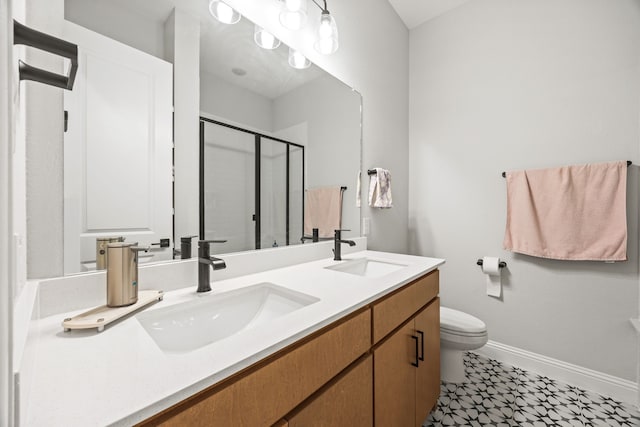 bathroom featuring baseboards, double vanity, a sink, and a stall shower
