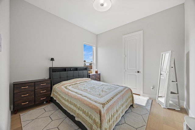 bedroom featuring baseboards and light wood-type flooring