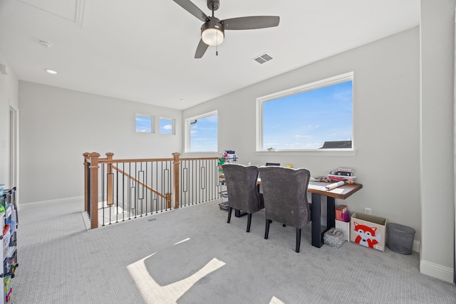 office area featuring baseboards, carpet floors, visible vents, and a ceiling fan