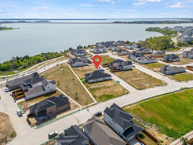 drone / aerial view featuring a residential view and a water view