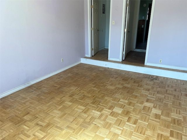 empty room featuring baseboards