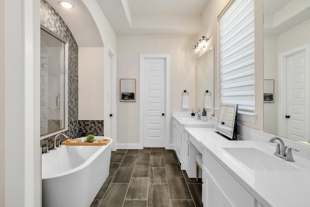 1030 Lone Grove Ln, Prosper, TX 75078 - bathroom with double vanity, a sink, a freestanding tub, and walk in shower