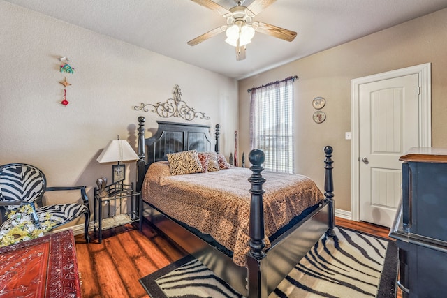 bedroom featuring wood finished floors, ceiling fan, and baseboards