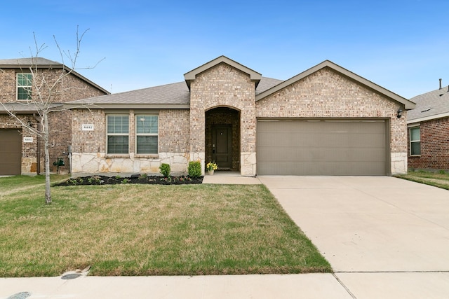 6237 Abby Dr, Celina, TX 76227 - view of front of home with a front lawn, driveway, an attached garage, brick siding, and roof with shingles