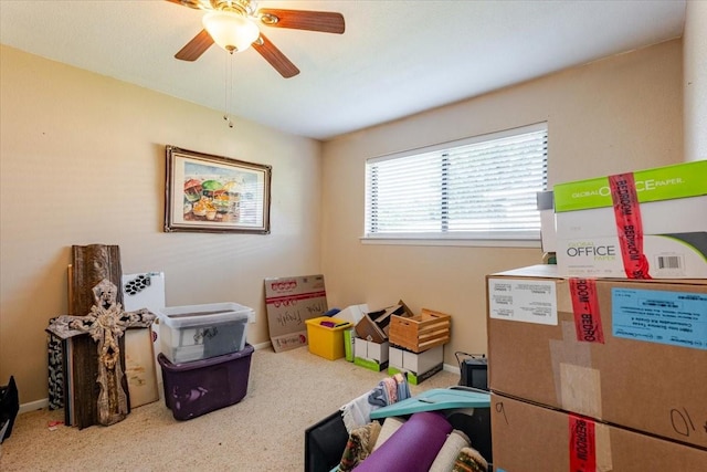 interior space with baseboards, carpet flooring, and ceiling fan