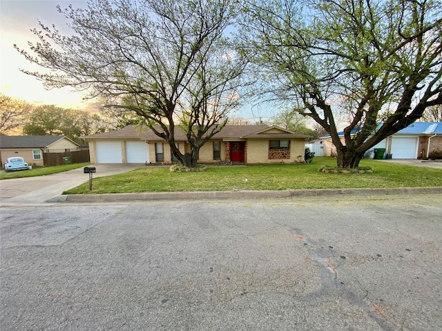 single story home with a front lawn, driveway, and fence