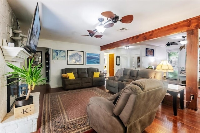 living room featuring wood finished floors, visible vents, and a ceiling fan